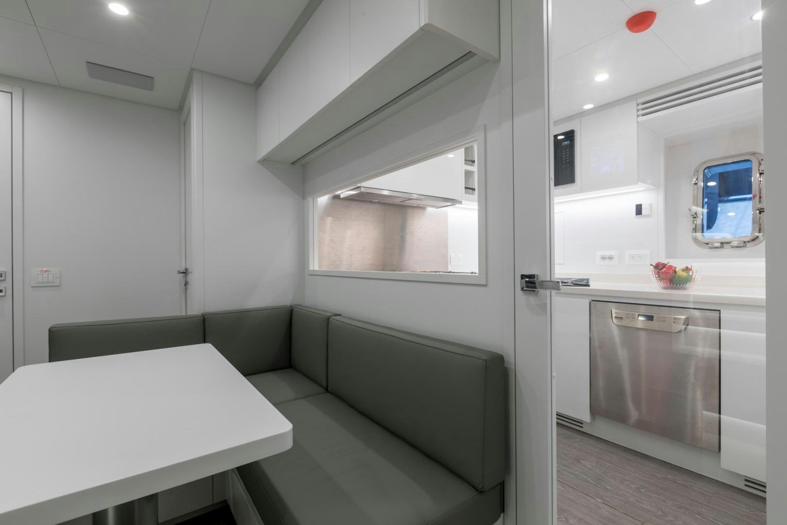 a room with a table and a couch aboard NANA I Yacht for Sale