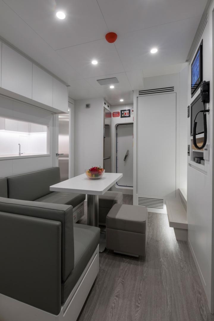 a room with a table and chairs aboard NANA I Yacht for Sale