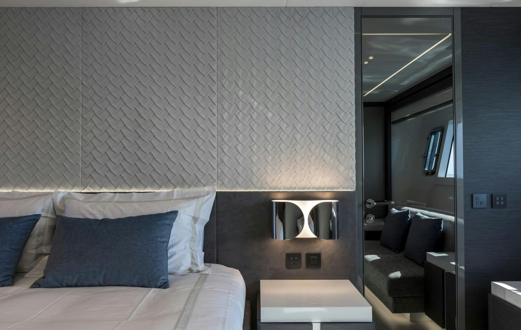 a bedroom with a bed and a mirror aboard NANA I Yacht for Sale