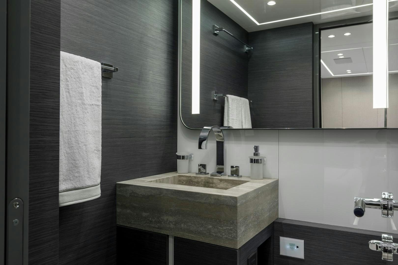 a bathroom with a sink and mirror aboard NANA I Yacht for Sale