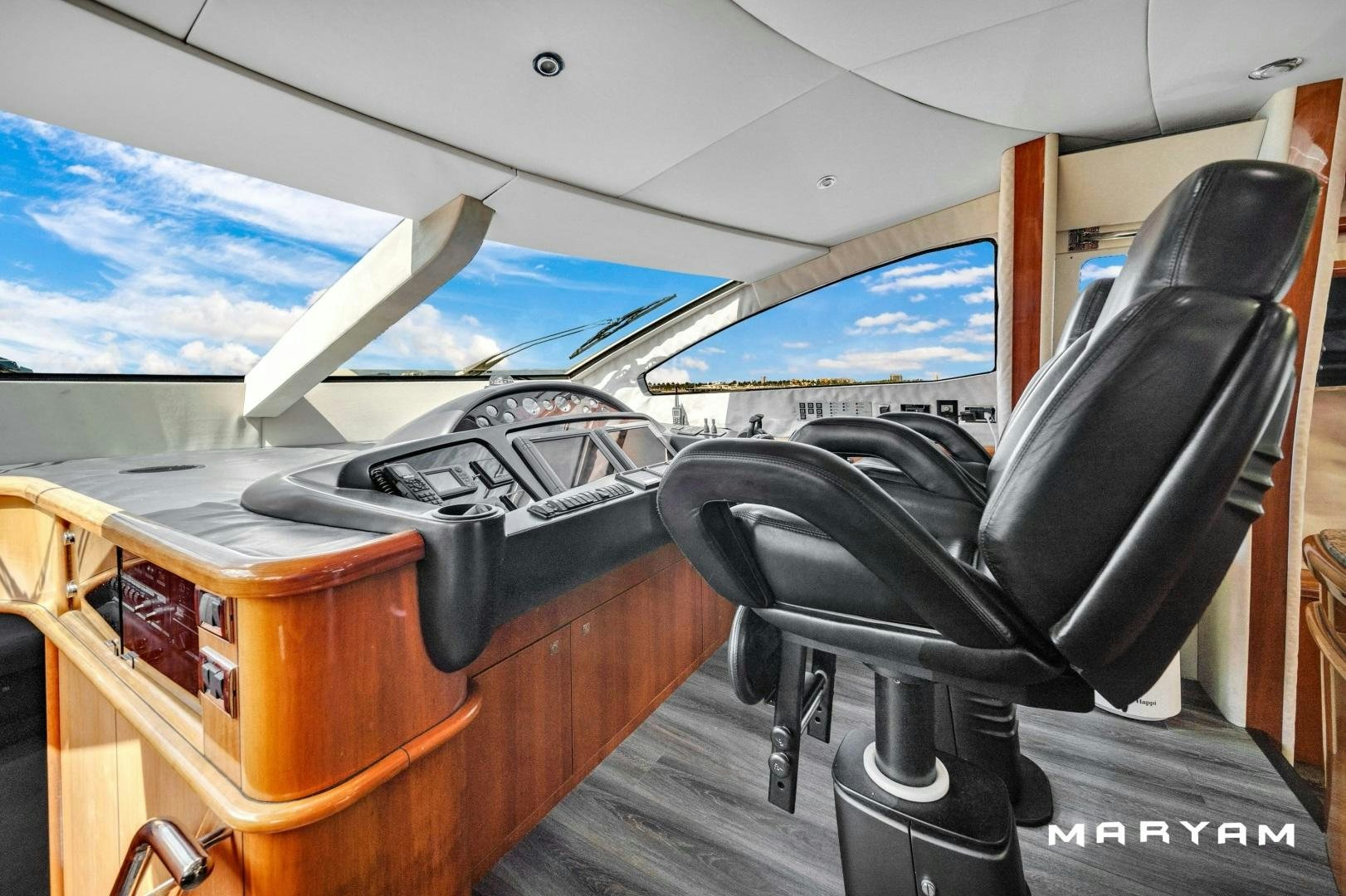 a black chair next to a black chair with a white airplane in the background aboard FINS UP Yacht for Sale
