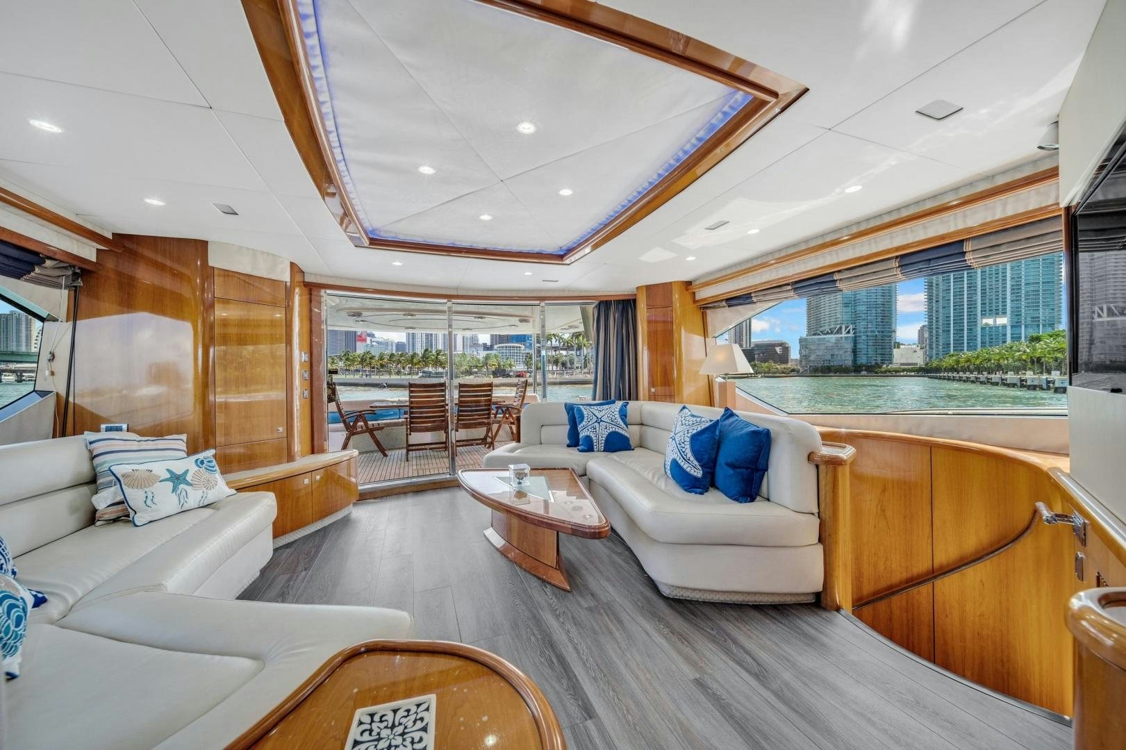 a living room with a large wood floor aboard FINS UP Yacht for Sale