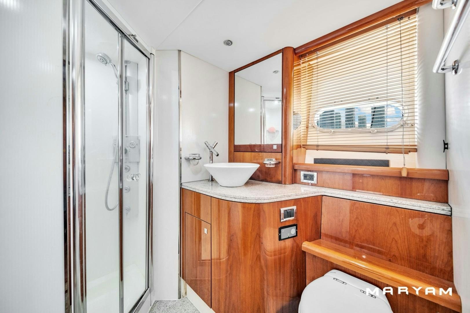 a bathroom with a sink and a mirror aboard FINS UP Yacht for Sale