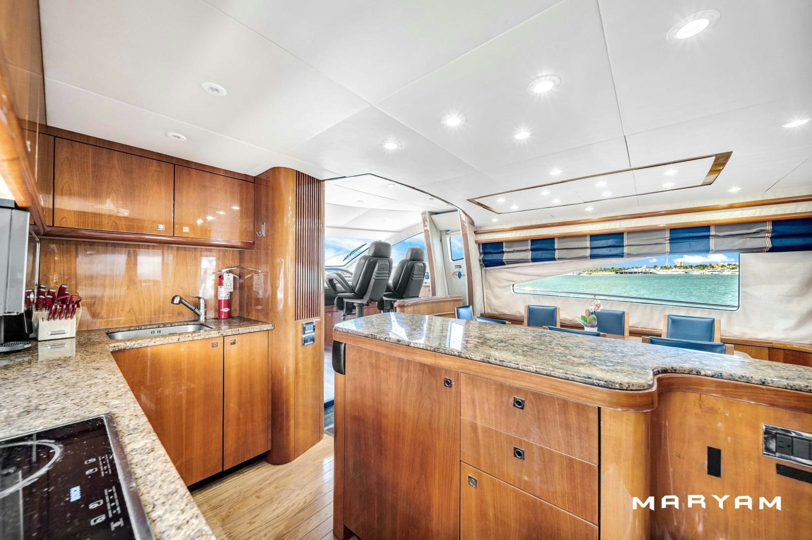 a kitchen with wooden cabinets aboard FINS UP Yacht for Sale