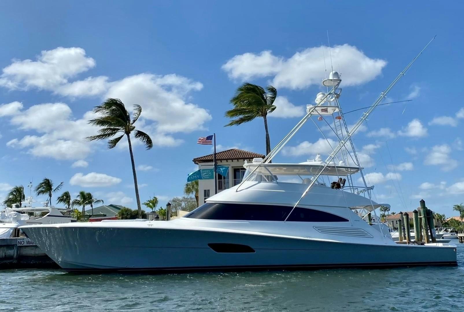 a white boat with a palm tree on the front aboard PASTIME Yacht for Sale