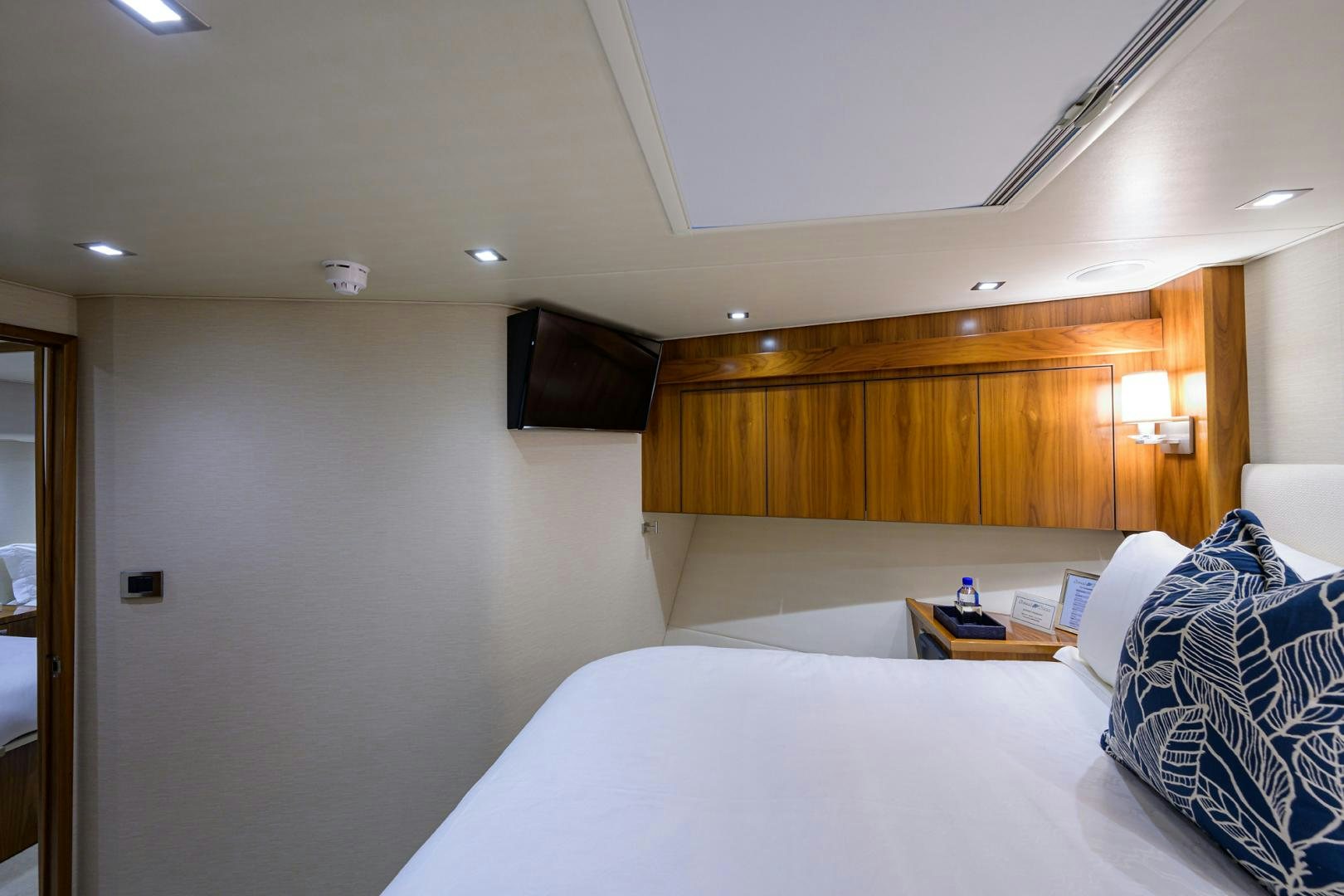 a bedroom with a bed and a television aboard PASTIME Yacht for Sale