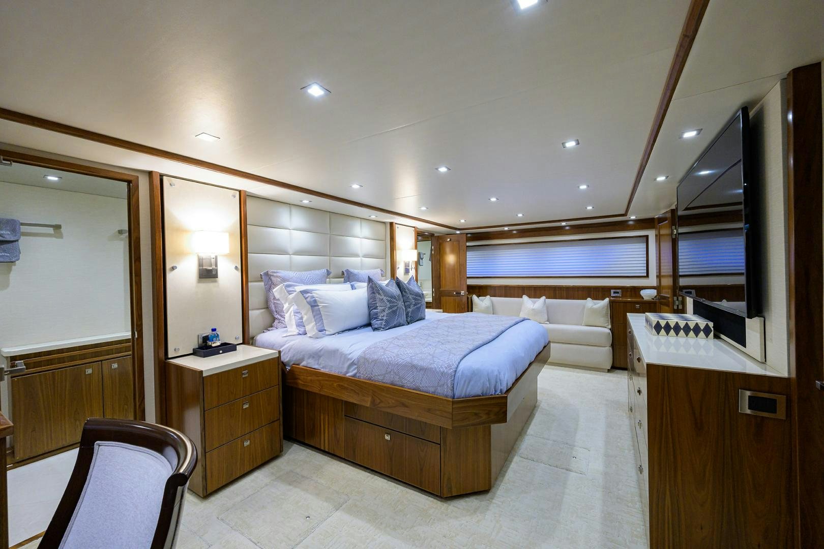 a bedroom with a bed and a mirror aboard PASTIME Yacht for Sale