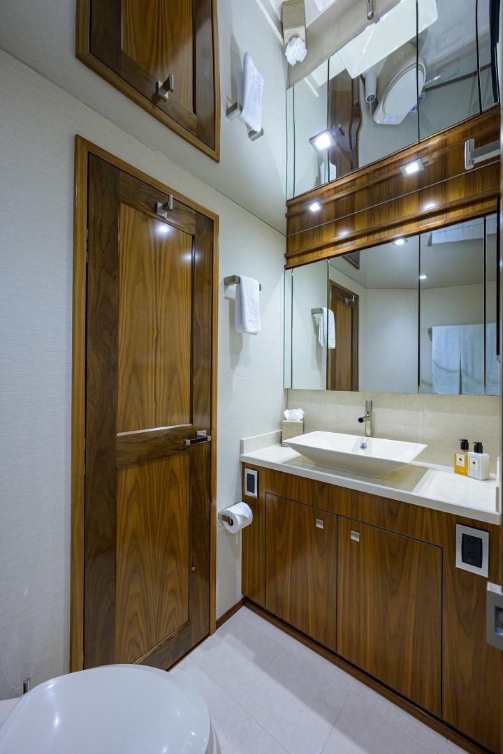 a bathroom with a wooden door aboard PASTIME Yacht for Sale