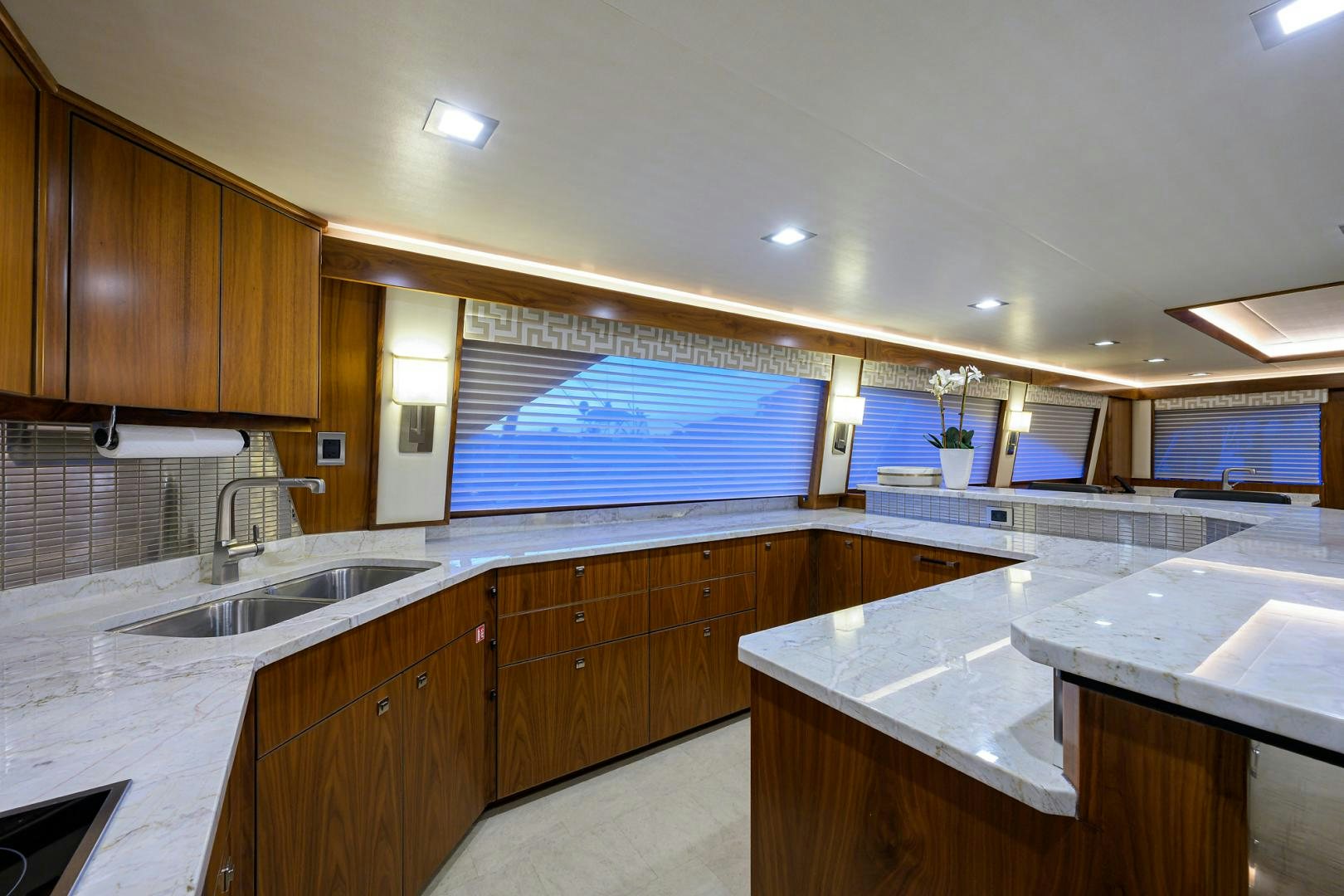 a kitchen with wooden cabinets aboard PASTIME Yacht for Sale