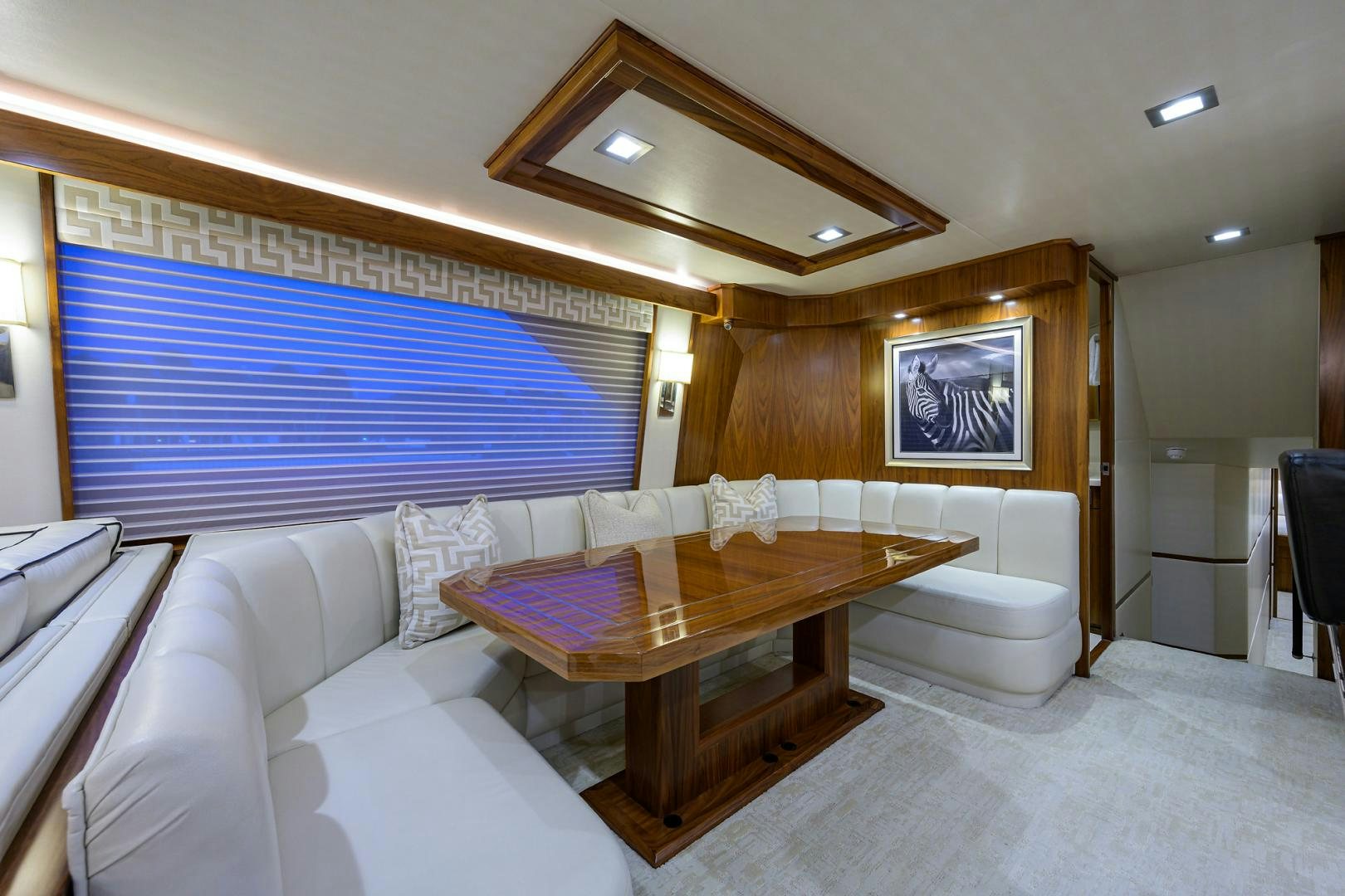 a living room with a table and couches aboard PASTIME Yacht for Sale