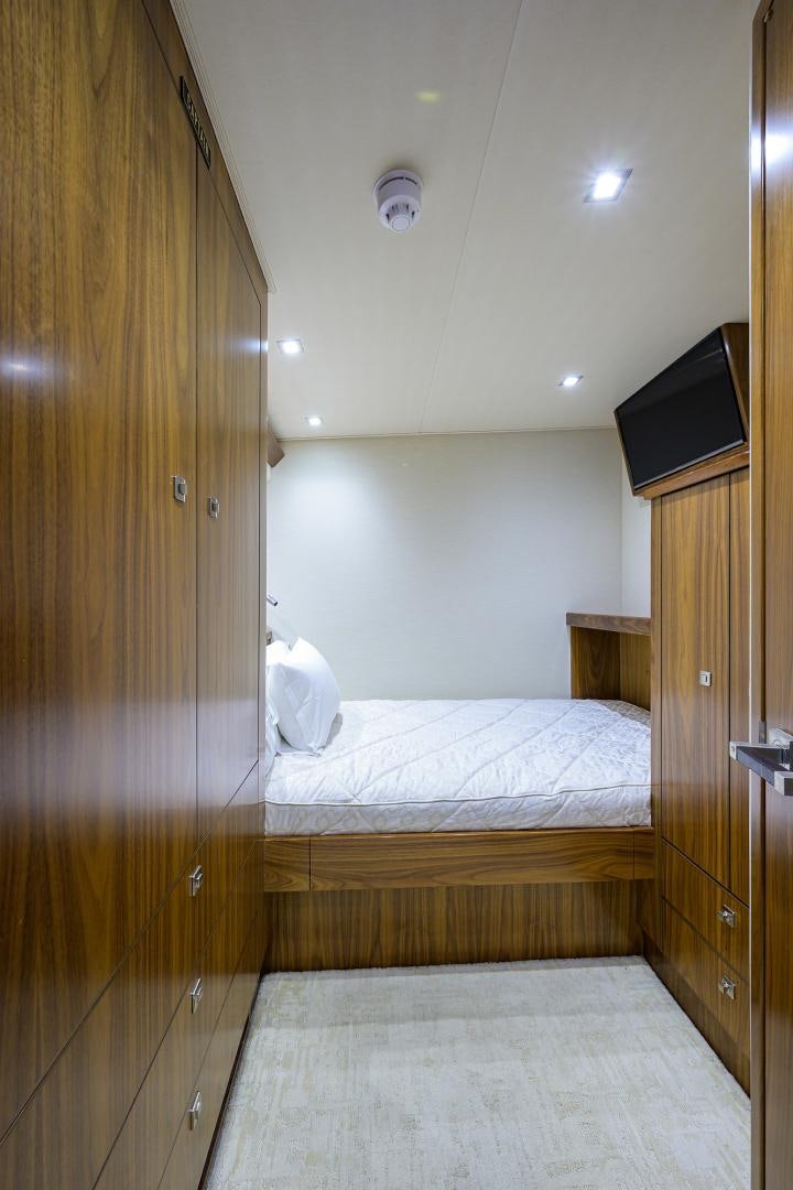 a bedroom with a wood door aboard PASTIME Yacht for Sale