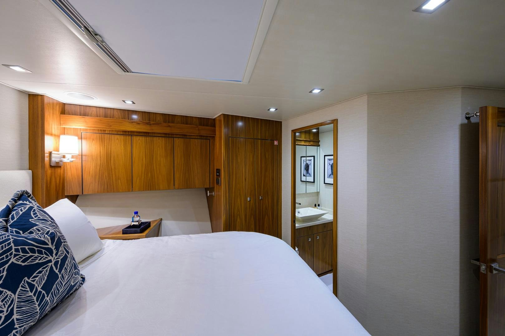 a hotel room with a bed and a mirror aboard PASTIME Yacht for Sale