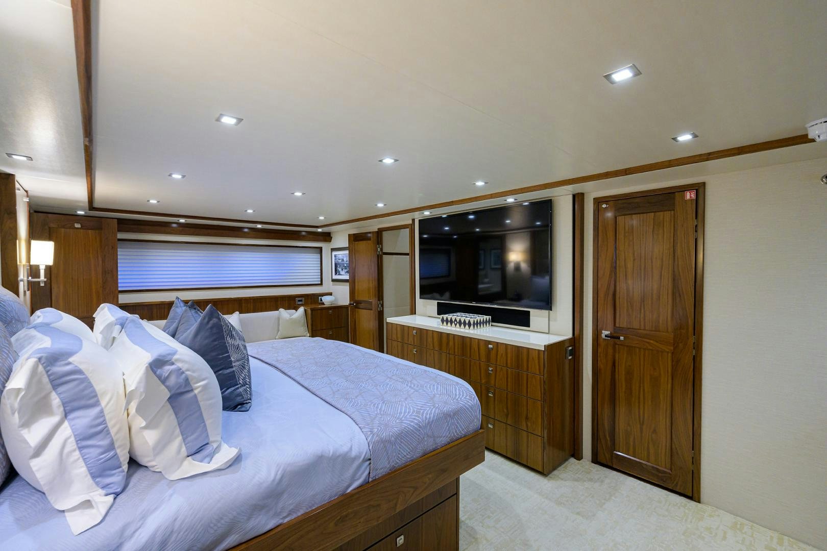 a hotel room with a bed and tv aboard PASTIME Yacht for Sale