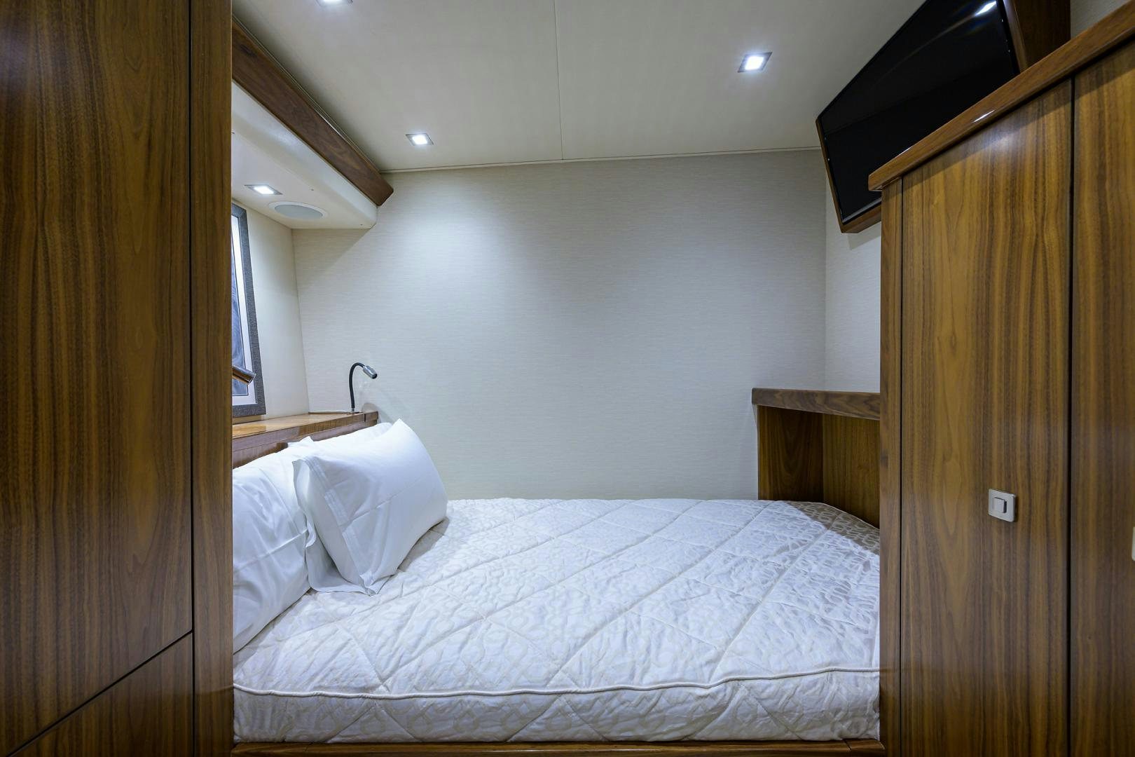 a bed with a white sheet aboard PASTIME Yacht for Sale
