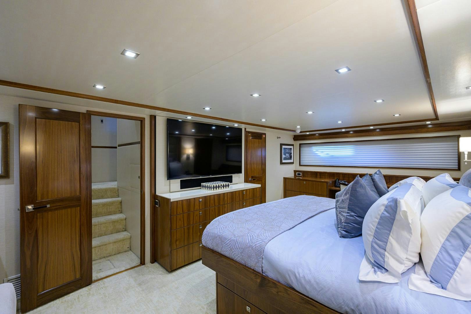 a bedroom with a bed and a television aboard PASTIME Yacht for Sale