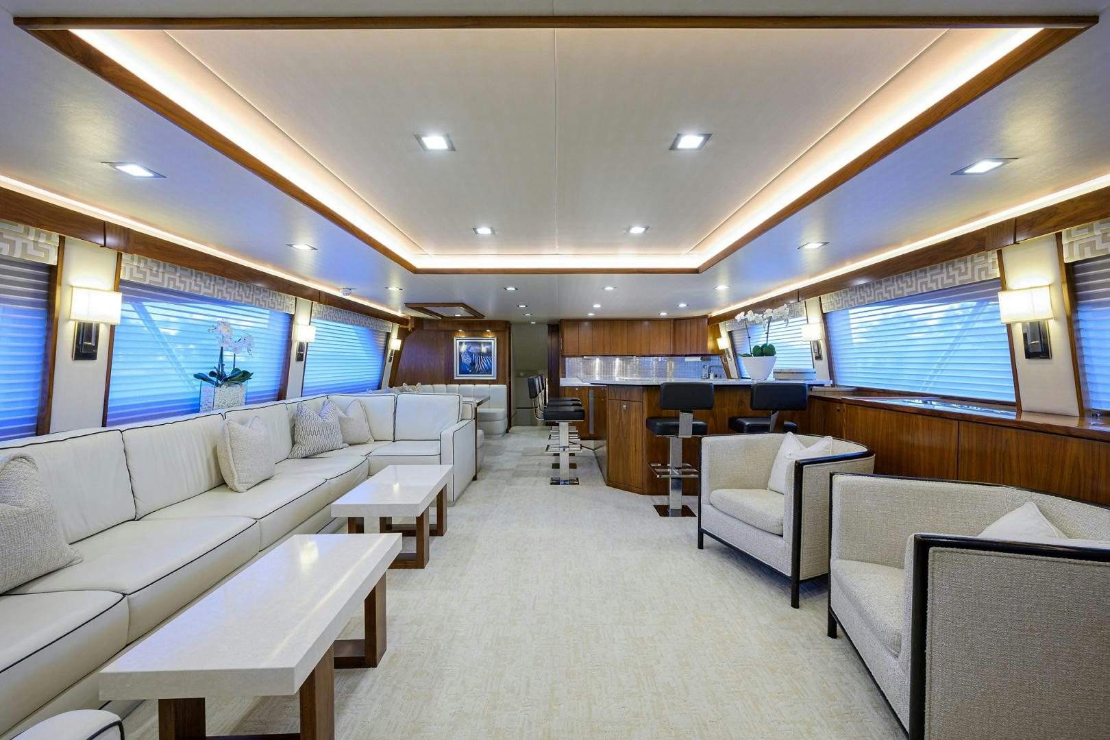 a large living room with white couches and a large window aboard PASTIME Yacht for Sale