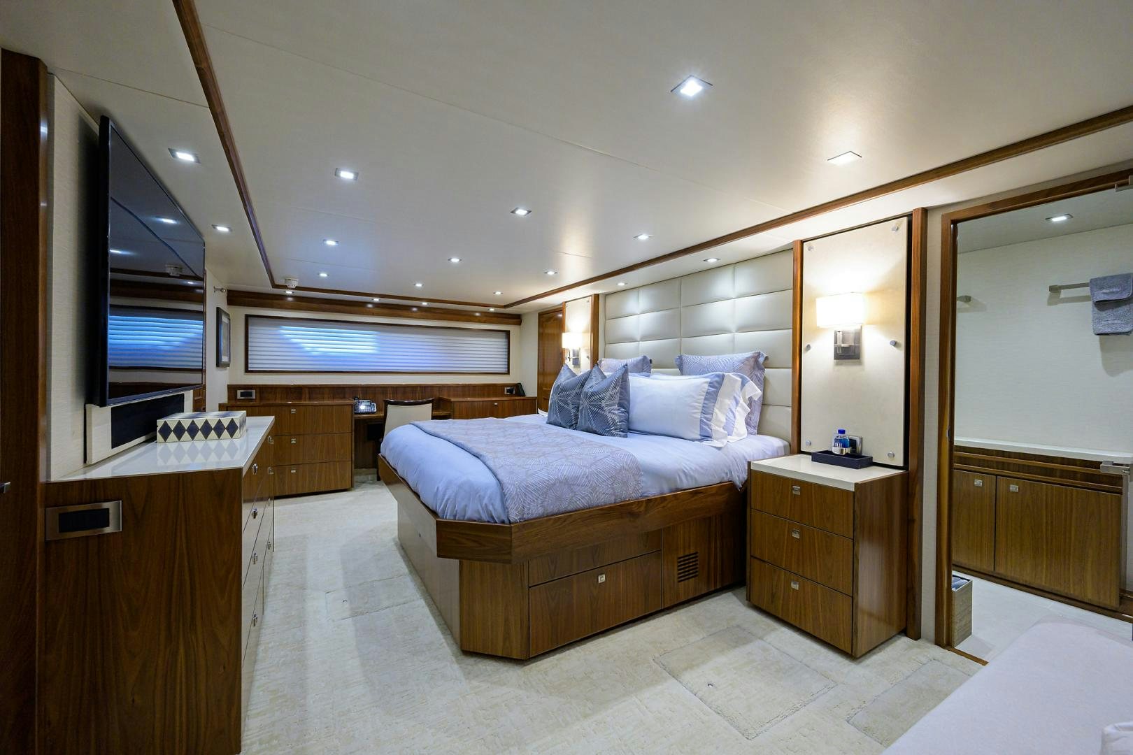 a bedroom with a bed and a mirror aboard PASTIME Yacht for Sale