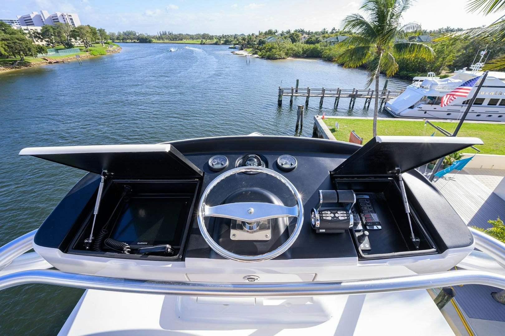 a boat with a steering wheel and a boat in the water aboard PASTIME Yacht for Sale