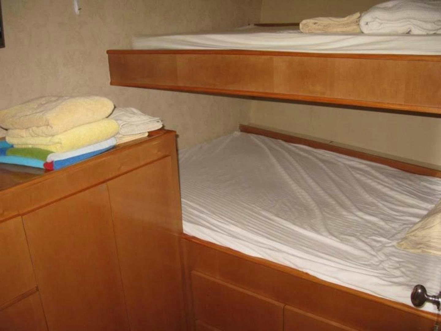 a bed with white sheets aboard TRUE NORTH Yacht for Sale