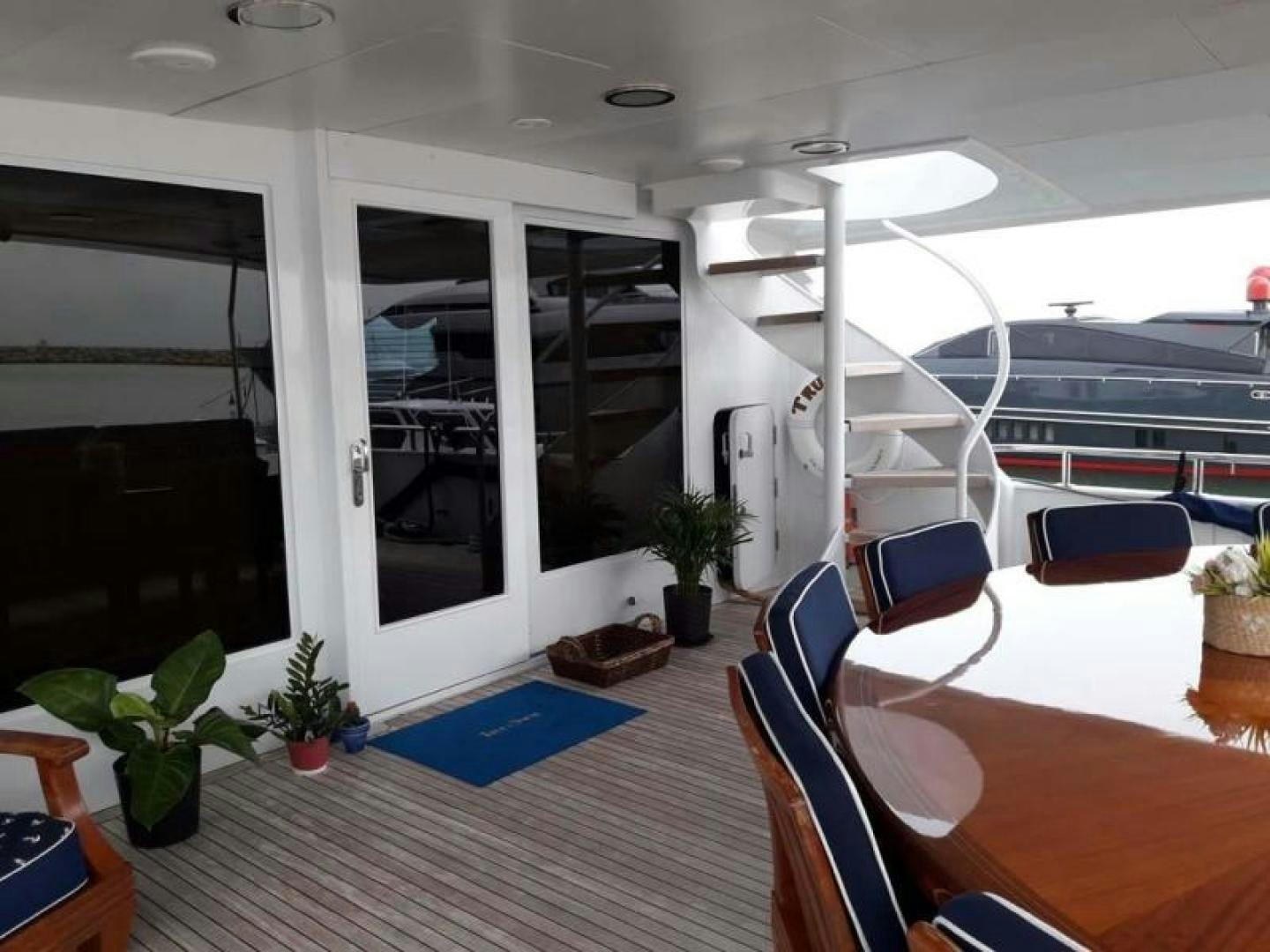 a room with a staircase and plants aboard TRUE NORTH Yacht for Sale