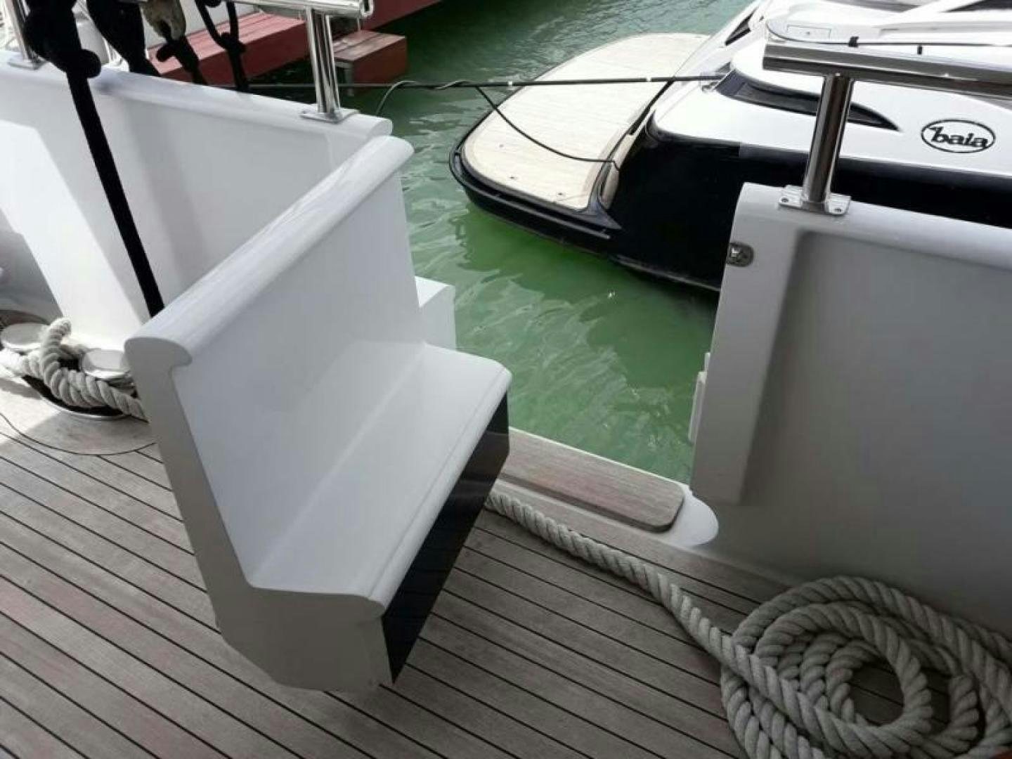 a white chair on a wooden deck aboard TRUE NORTH Yacht for Sale