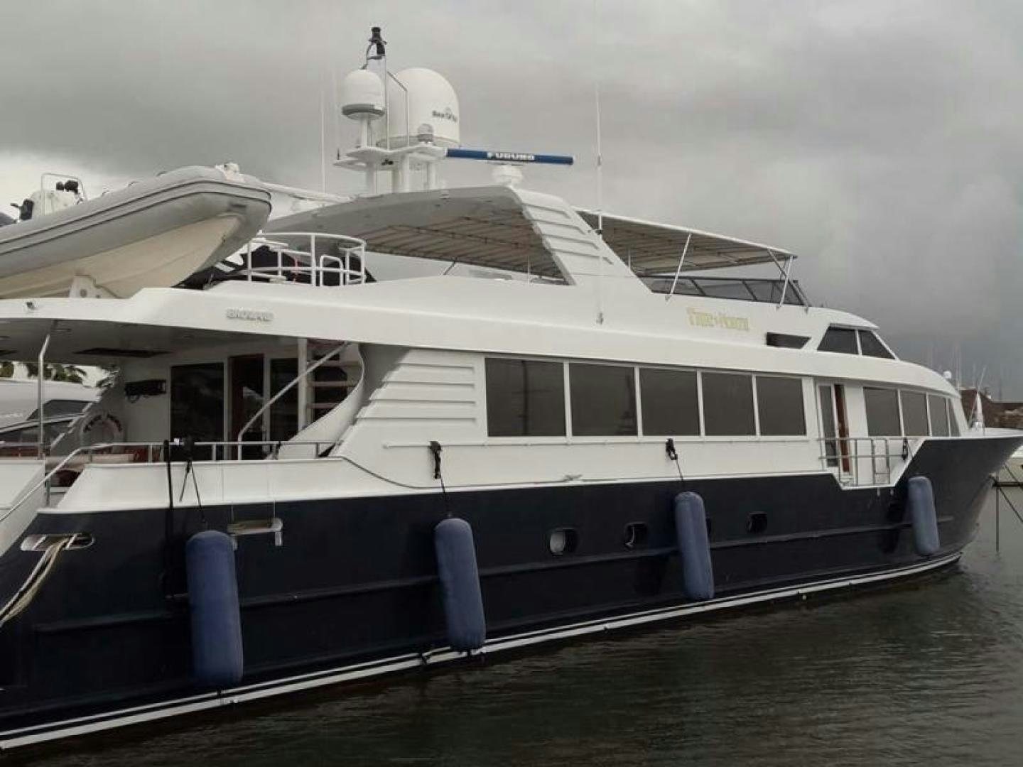 a white boat on a dock aboard TRUE NORTH Yacht for Sale