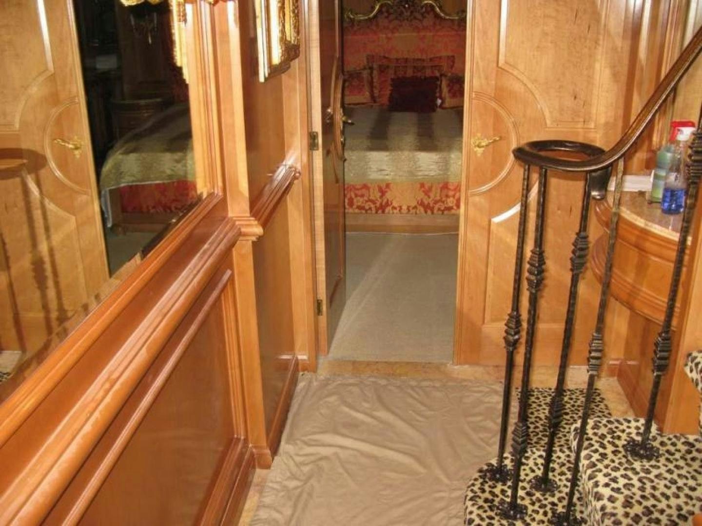 a room with a bed and a mirror aboard TRUE NORTH Yacht for Sale