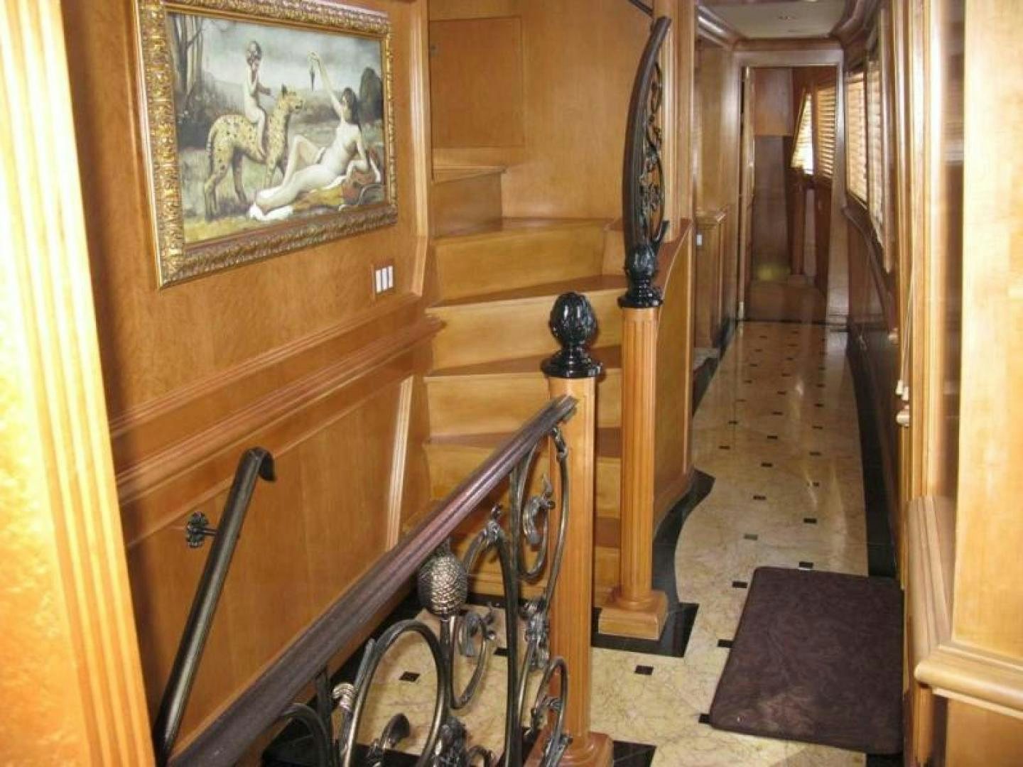 a hallway with a painting on the wall aboard TRUE NORTH Yacht for Sale