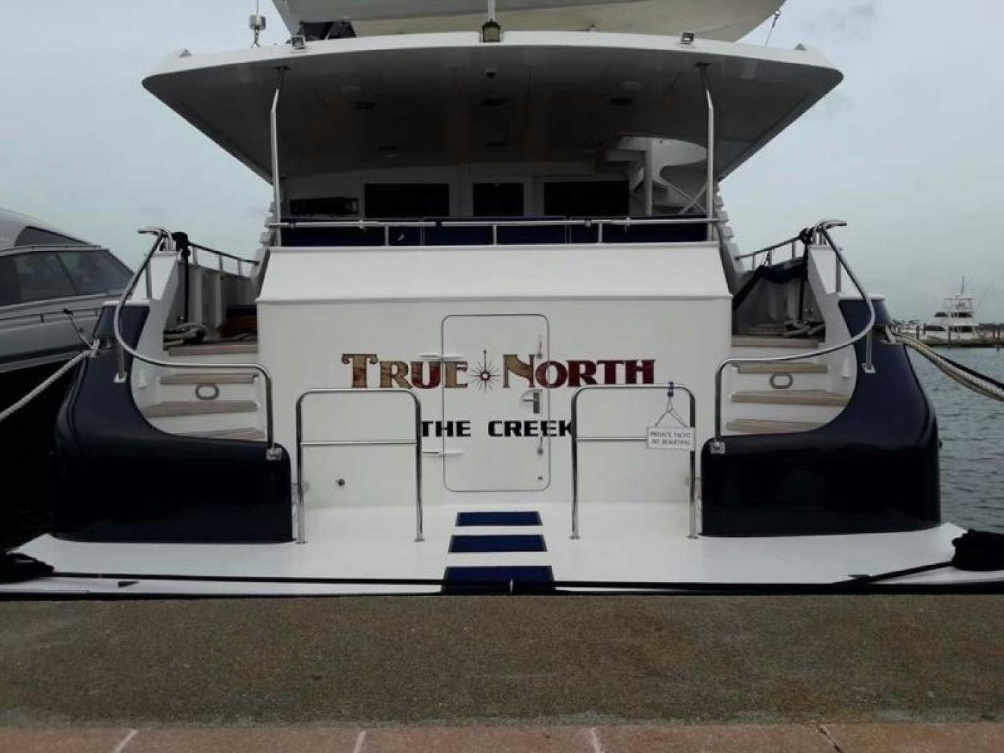 a boat docked at a pier aboard TRUE NORTH Yacht for Sale