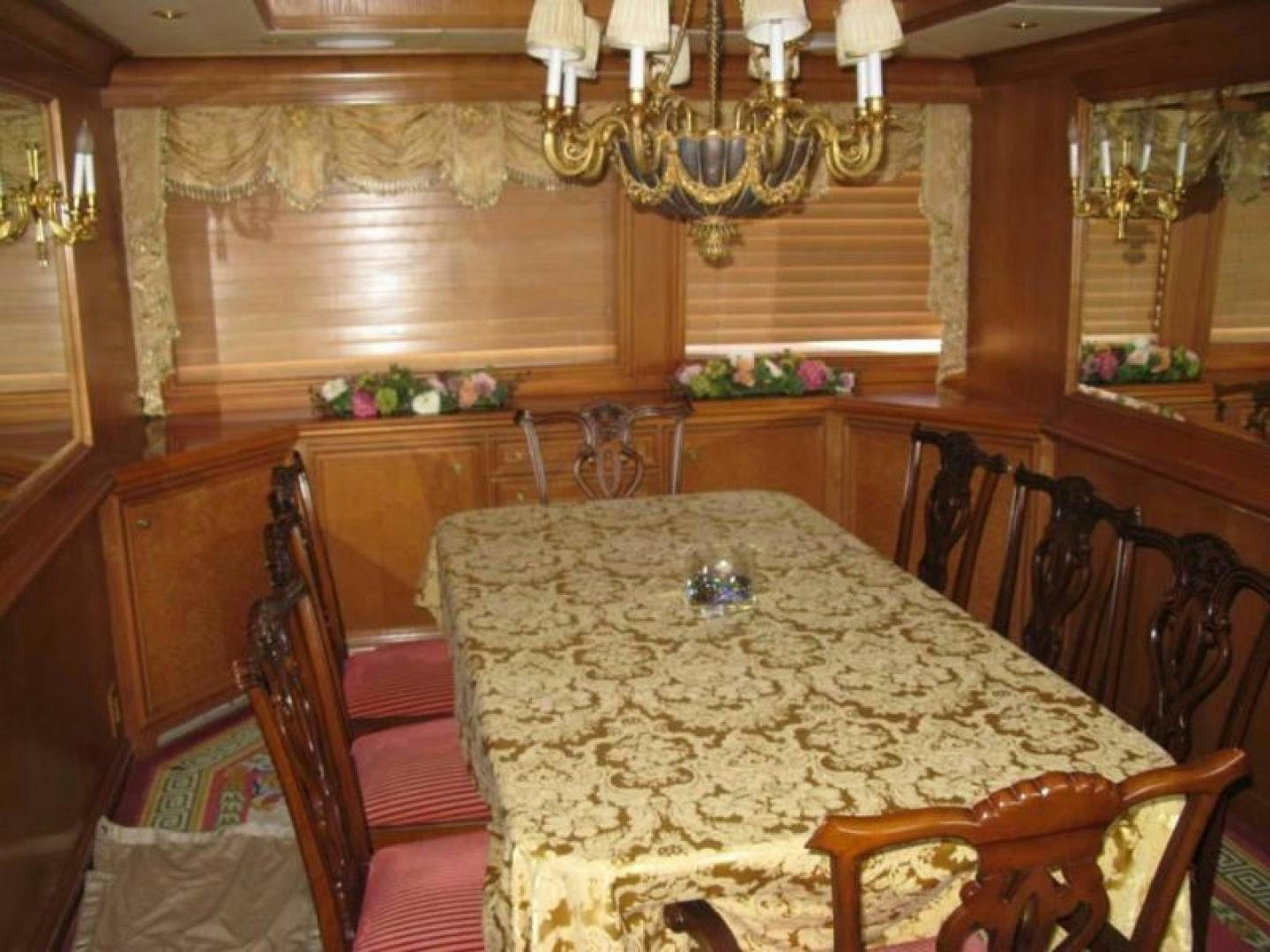 a dining room with a chandelier aboard TRUE NORTH Yacht for Sale