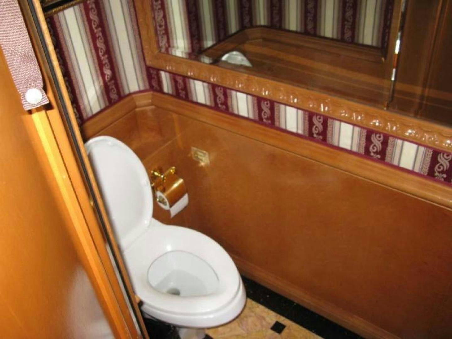 a bathroom with a toilet and bathtub aboard TRUE NORTH Yacht for Sale