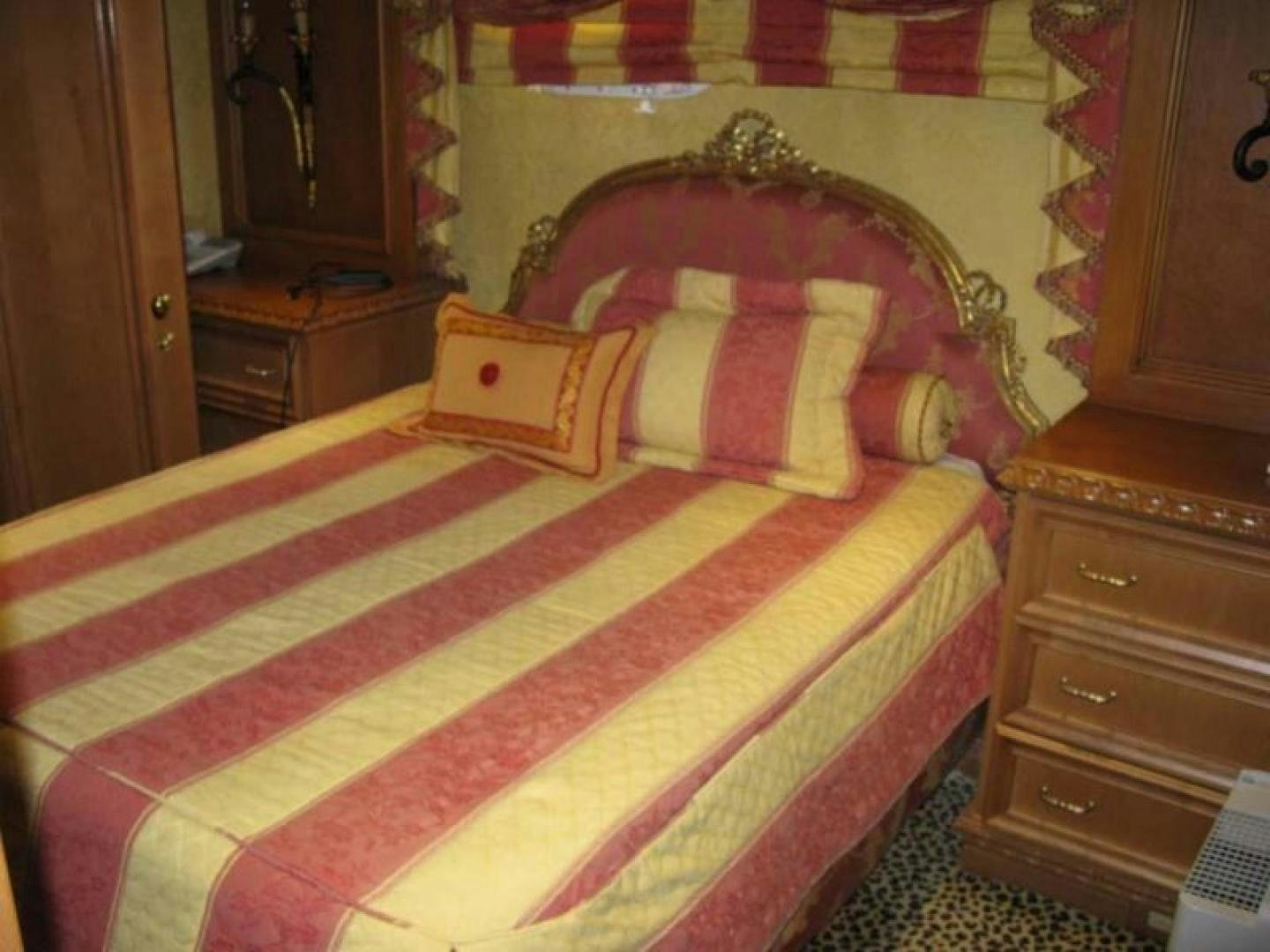 a bed with a colorful comforter aboard TRUE NORTH Yacht for Sale