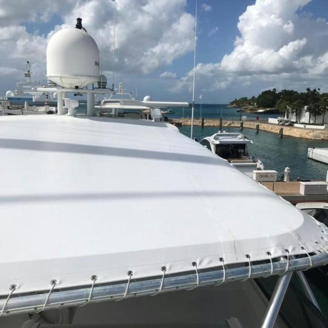 a large white boat in a harbor aboard TRUE NORTH Yacht for Sale