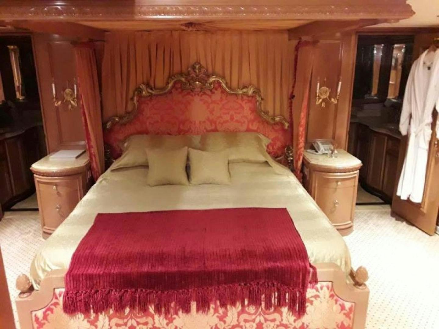 a bed with a red comforter aboard TRUE NORTH Yacht for Sale