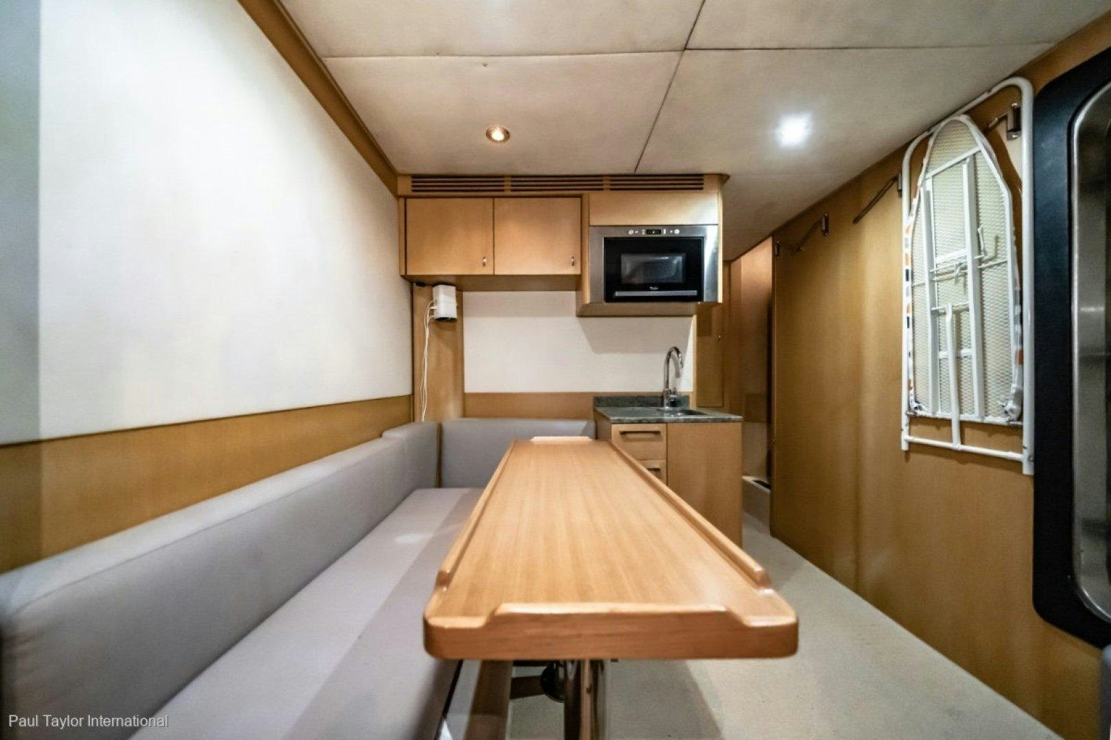 a room with a table and tv aboard SOPHIA Yacht for Sale