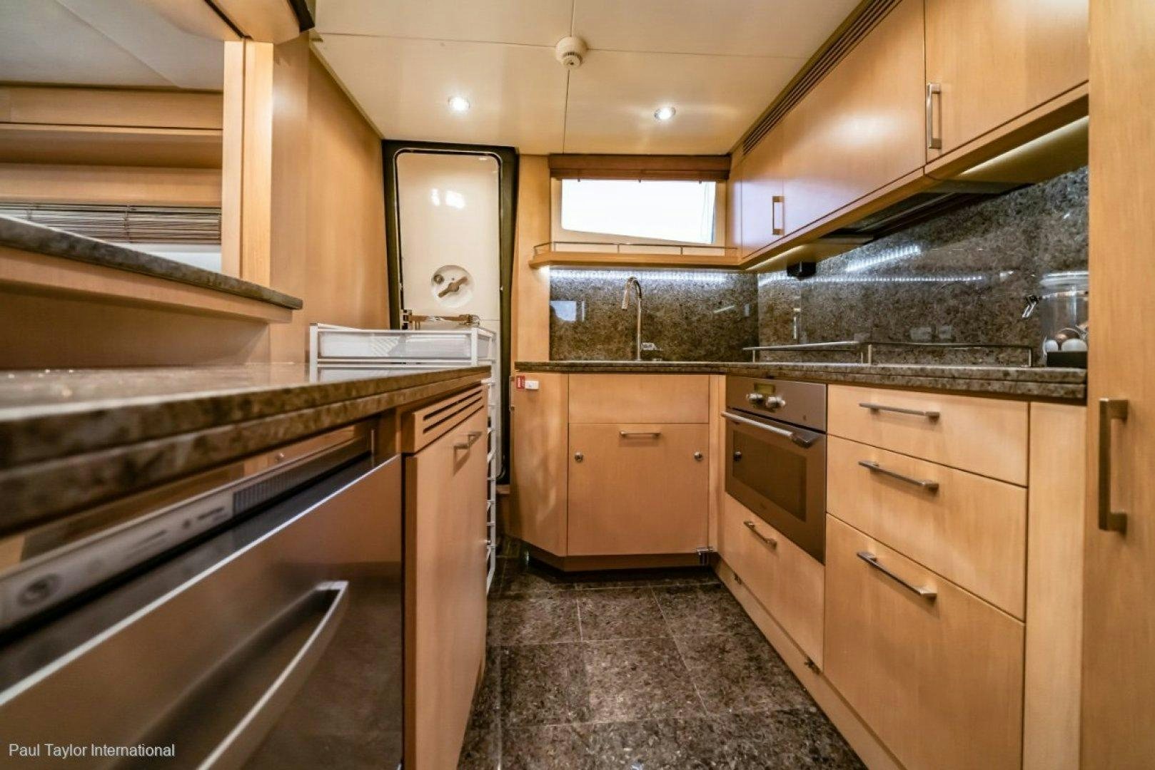 a kitchen with wooden cabinets aboard SOPHIA Yacht for Sale