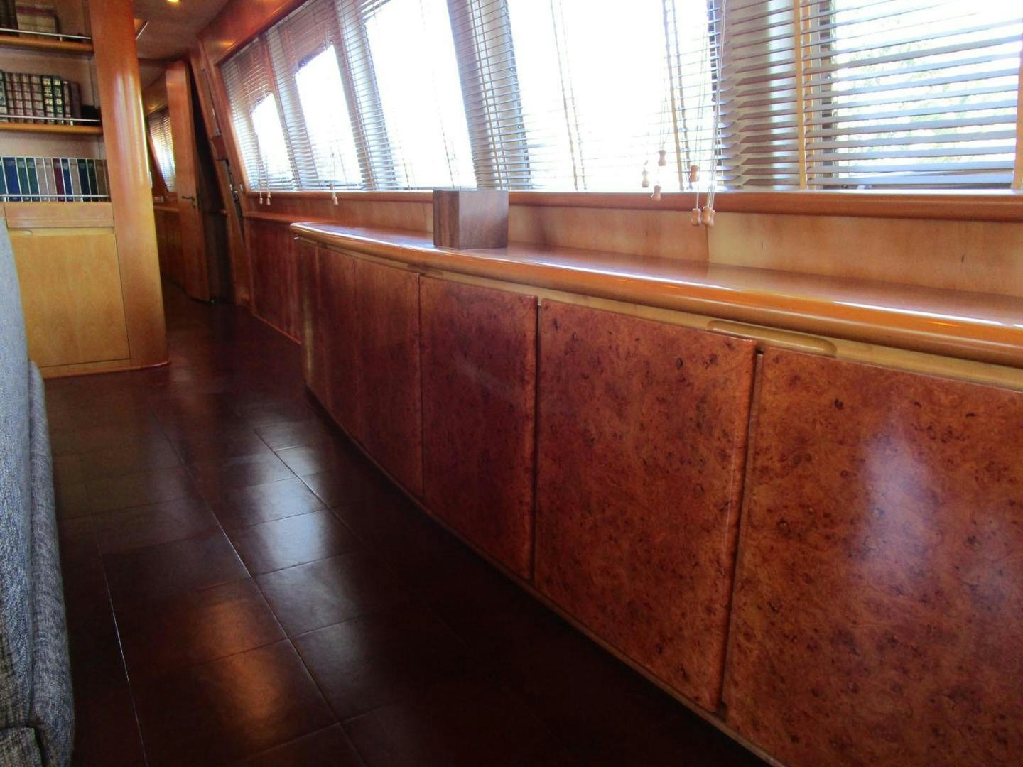 a room with a wood floor and a window with blinds aboard DEAR HENRI Yacht for Sale