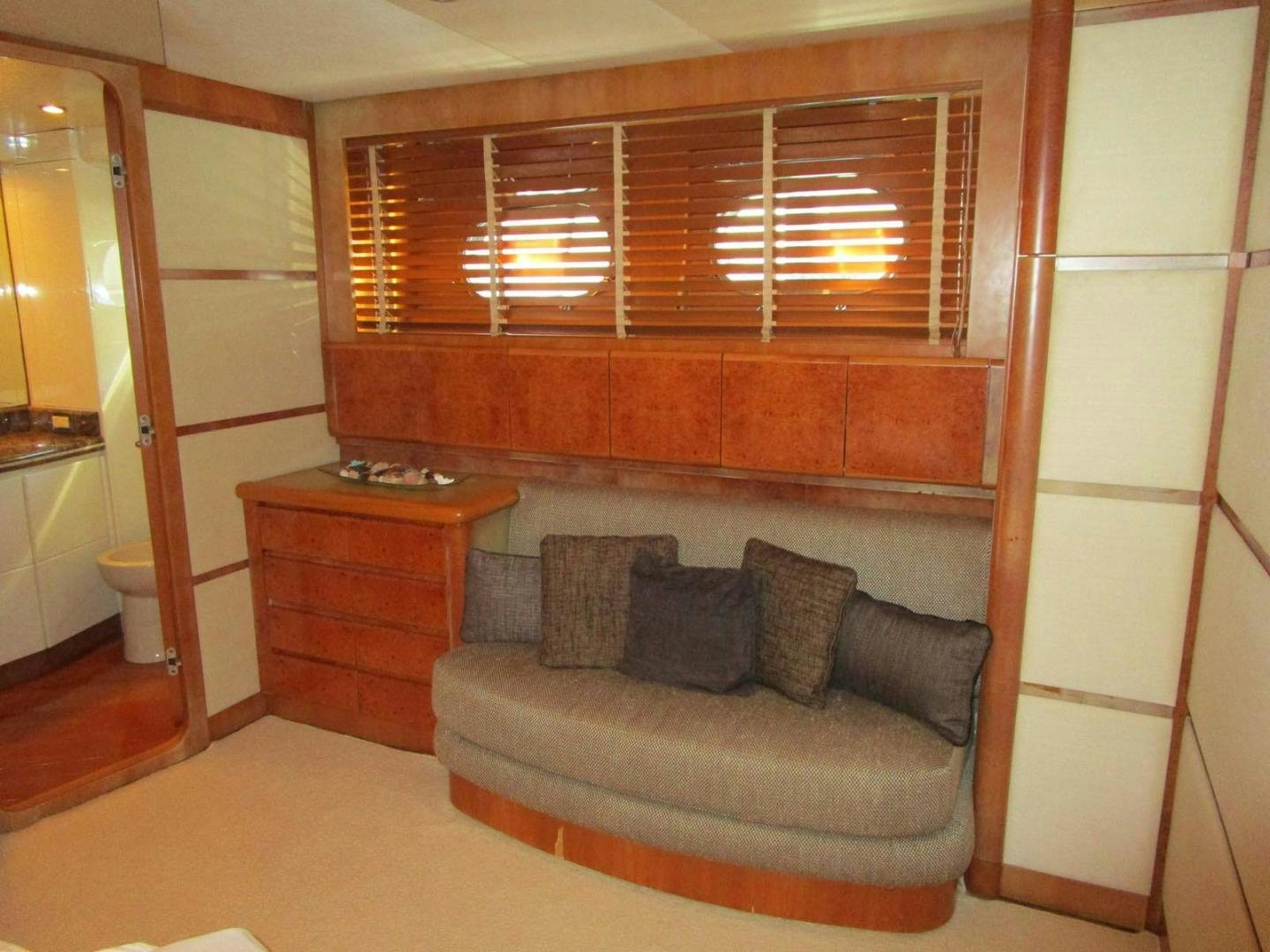 a room with a couch and a mirror aboard DEAR HENRI Yacht for Sale