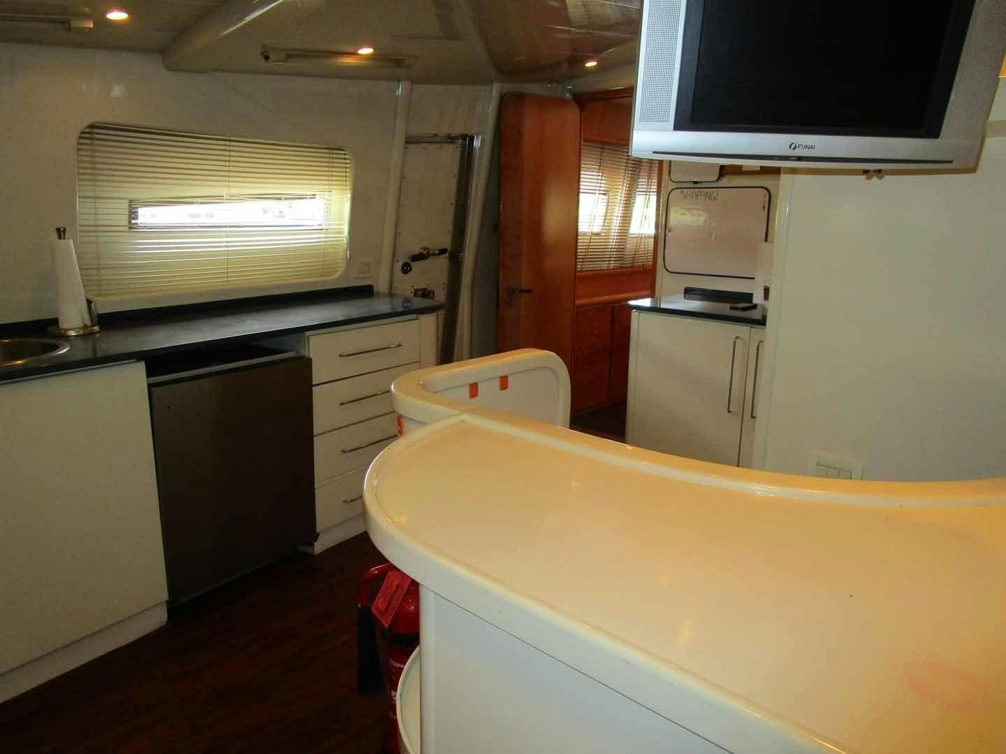 a kitchen with a microwave and cabinets aboard DEAR HENRI Yacht for Sale