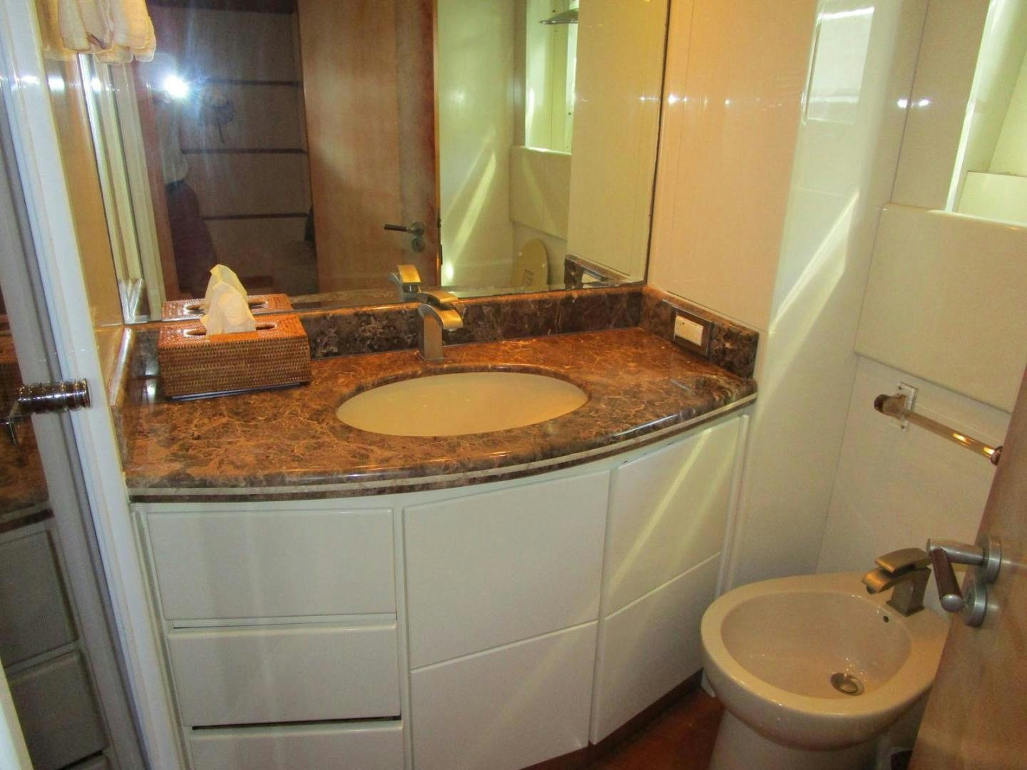 a bathroom with a sink and a mirror aboard DEAR HENRI Yacht for Sale