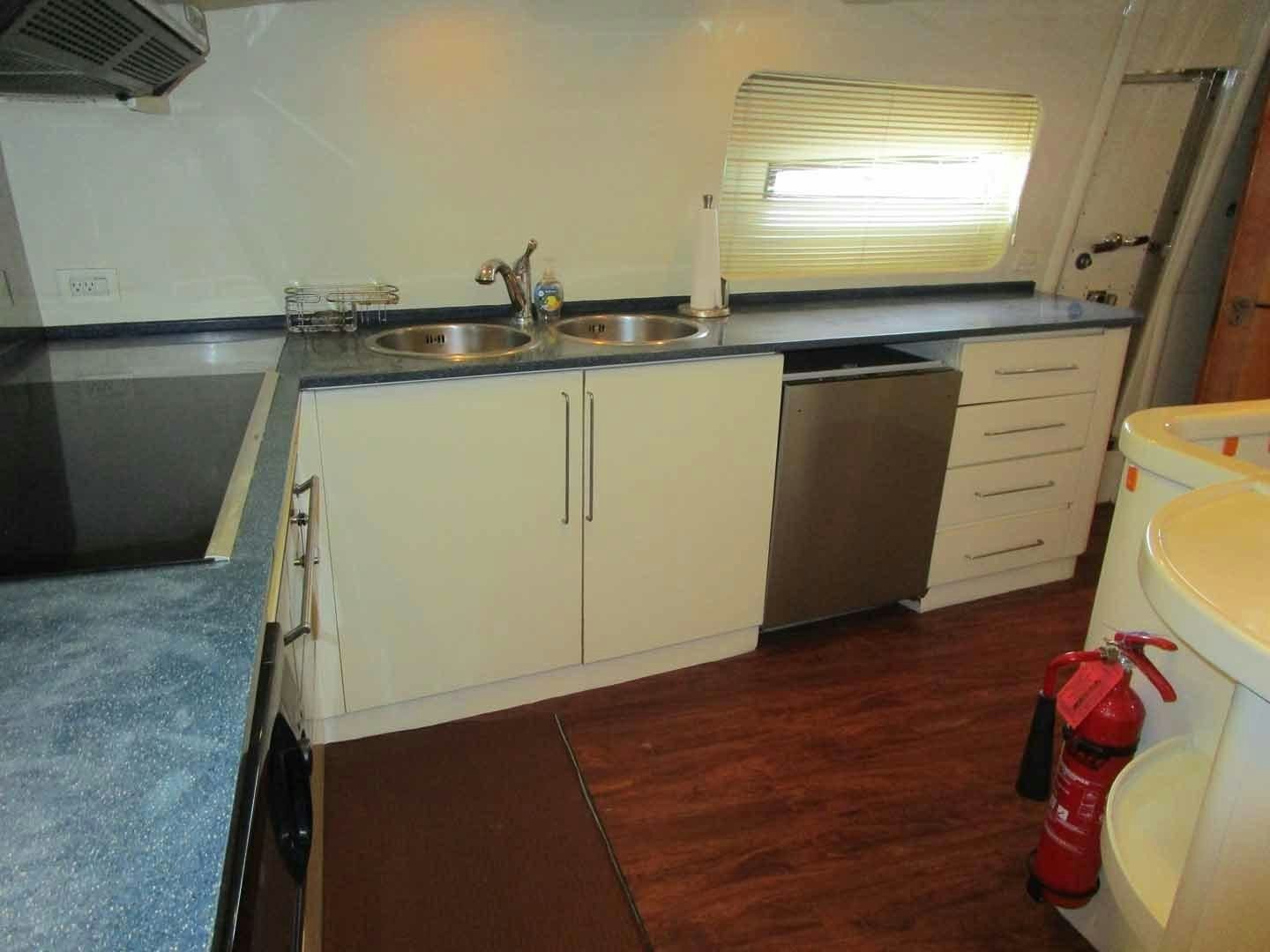 a kitchen with a sink and cabinets aboard DEAR HENRI Yacht for Sale