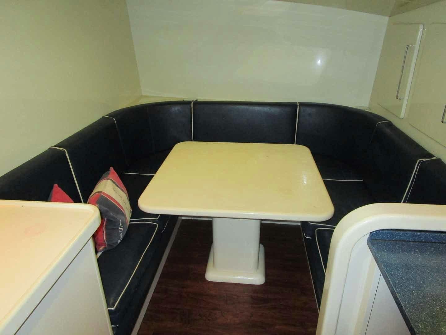 a black table with a white stool aboard DEAR HENRI Yacht for Sale