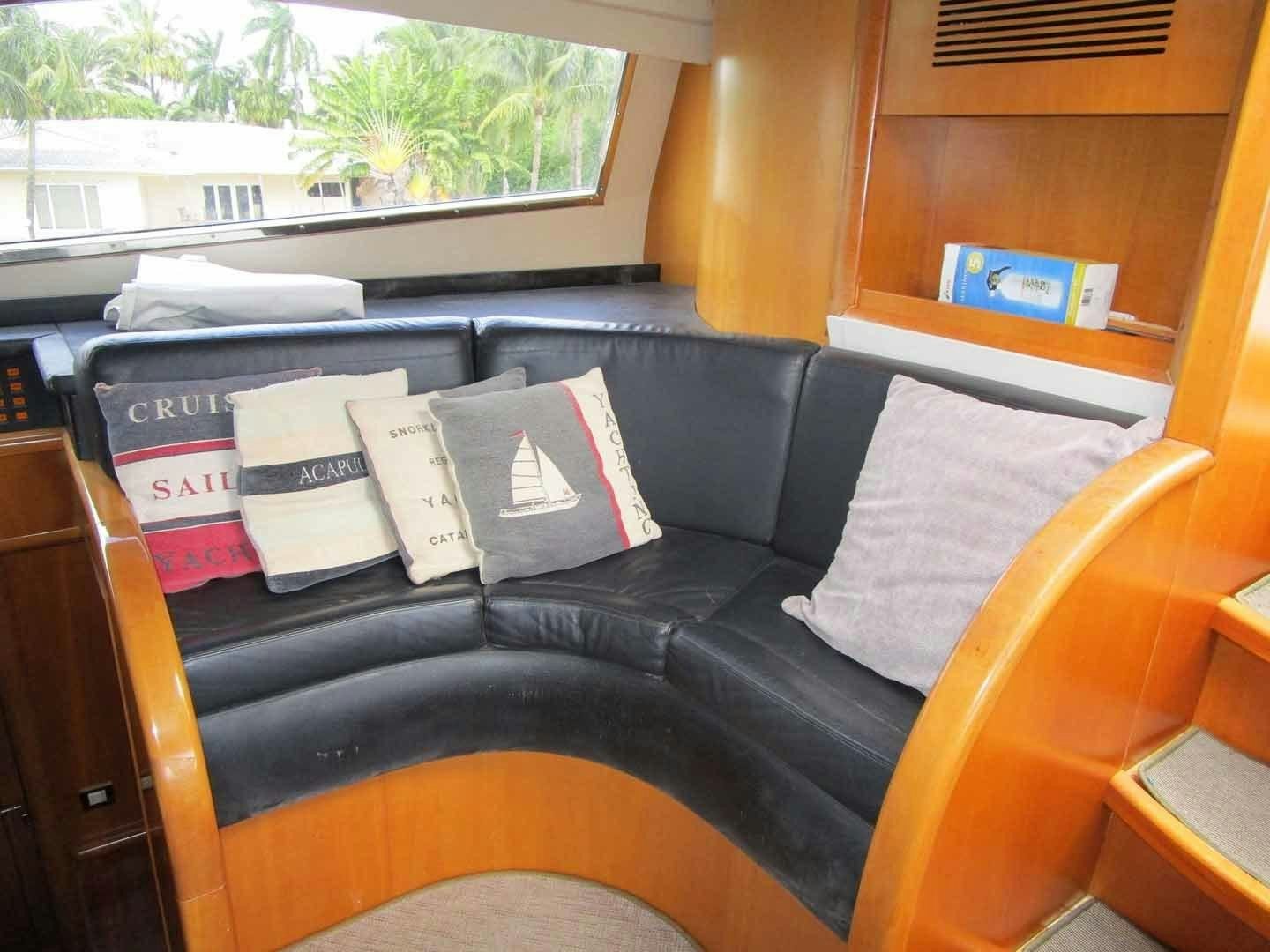 a couch with books on it aboard DEAR HENRI Yacht for Sale