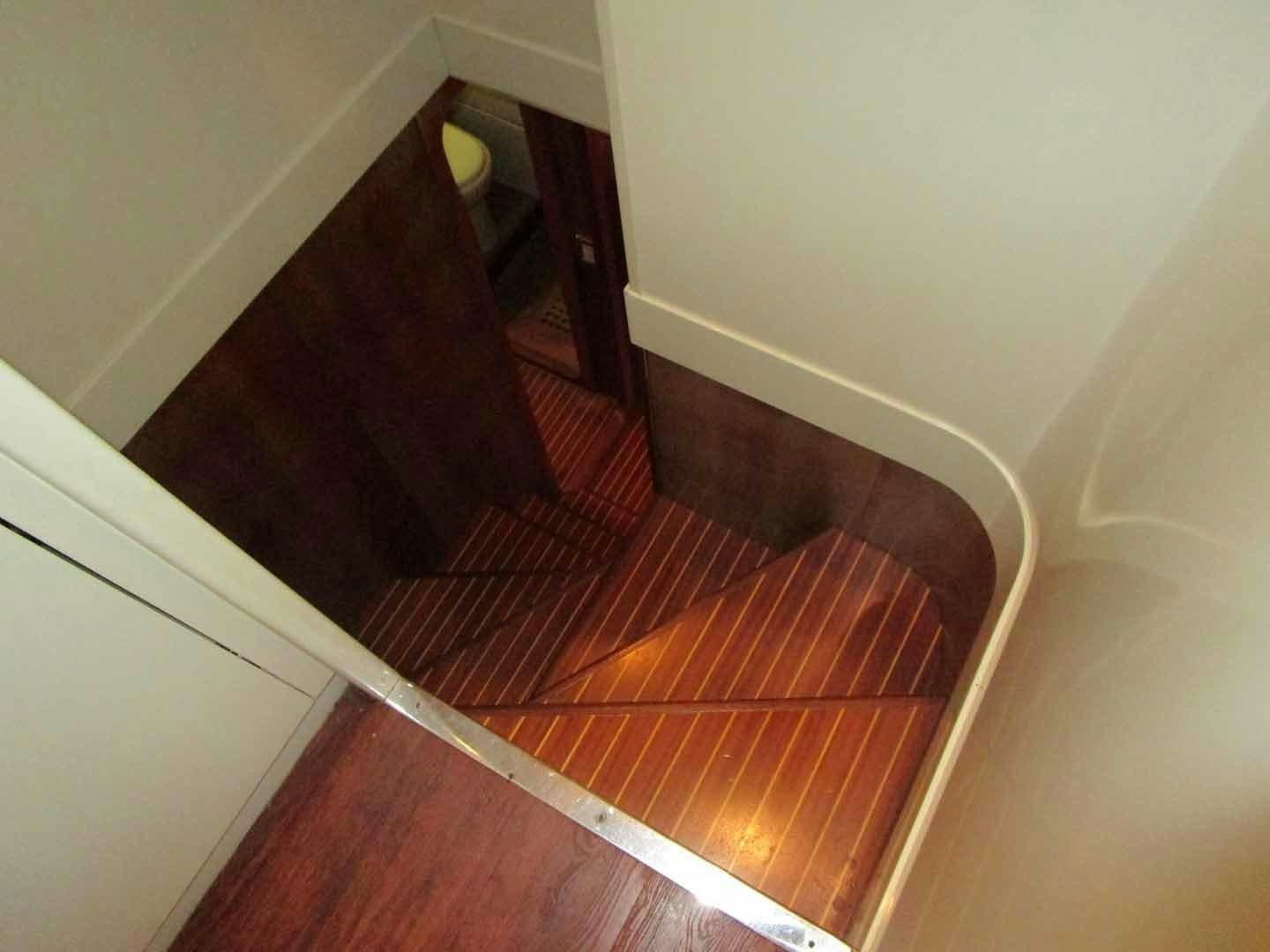 a staircase with a wood floor aboard DEAR HENRI Yacht for Sale