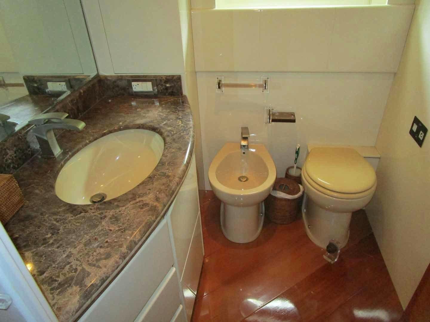 a bathroom with a sink toilet and a bathtub aboard DEAR HENRI Yacht for Sale