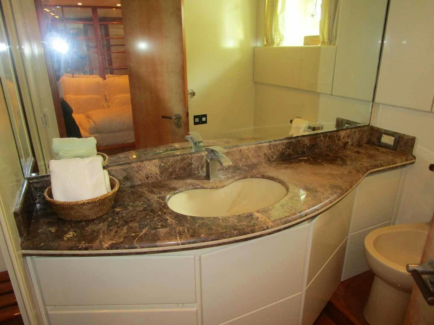 a bathroom with a sink and toilet aboard DEAR HENRI Yacht for Sale