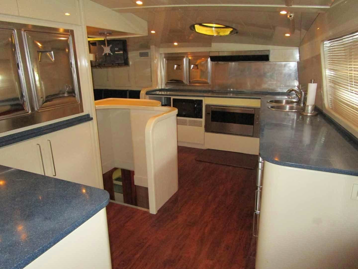 a kitchen with a dinning table aboard DEAR HENRI Yacht for Sale