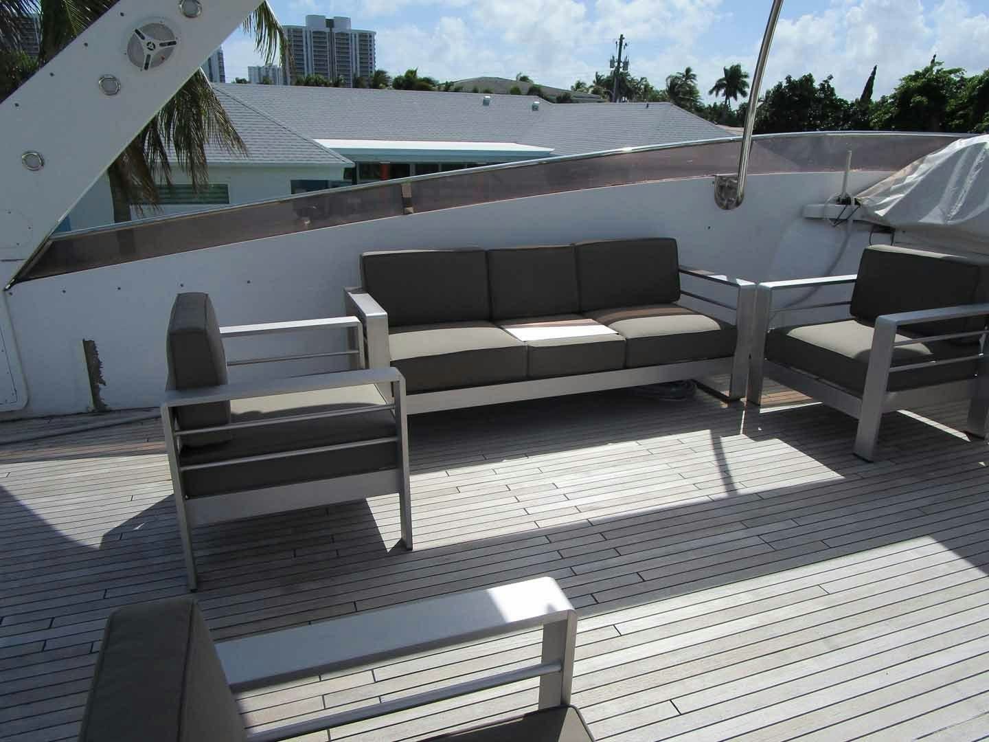 a deck with a couch and a pool aboard DEAR HENRI Yacht for Sale