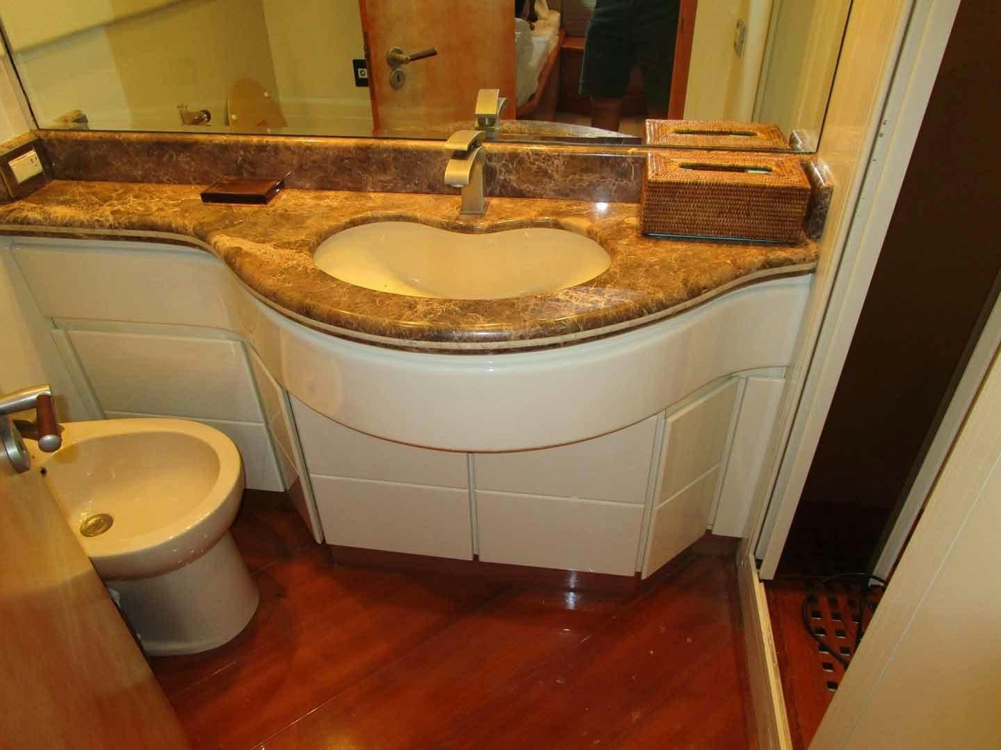 a bathroom with a countertop sink aboard DEAR HENRI Yacht for Sale