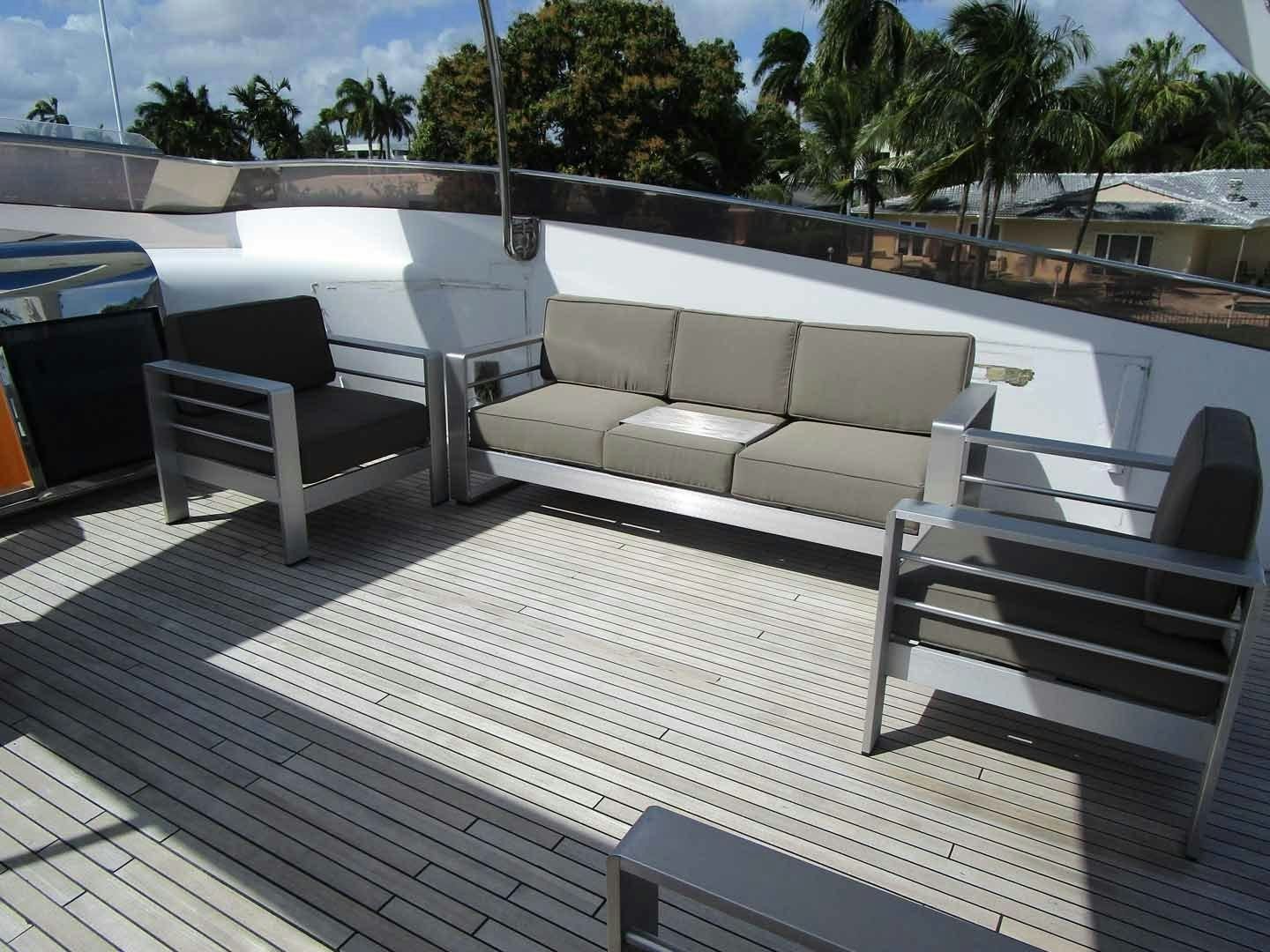 a deck with couches and chairs aboard DEAR HENRI Yacht for Sale